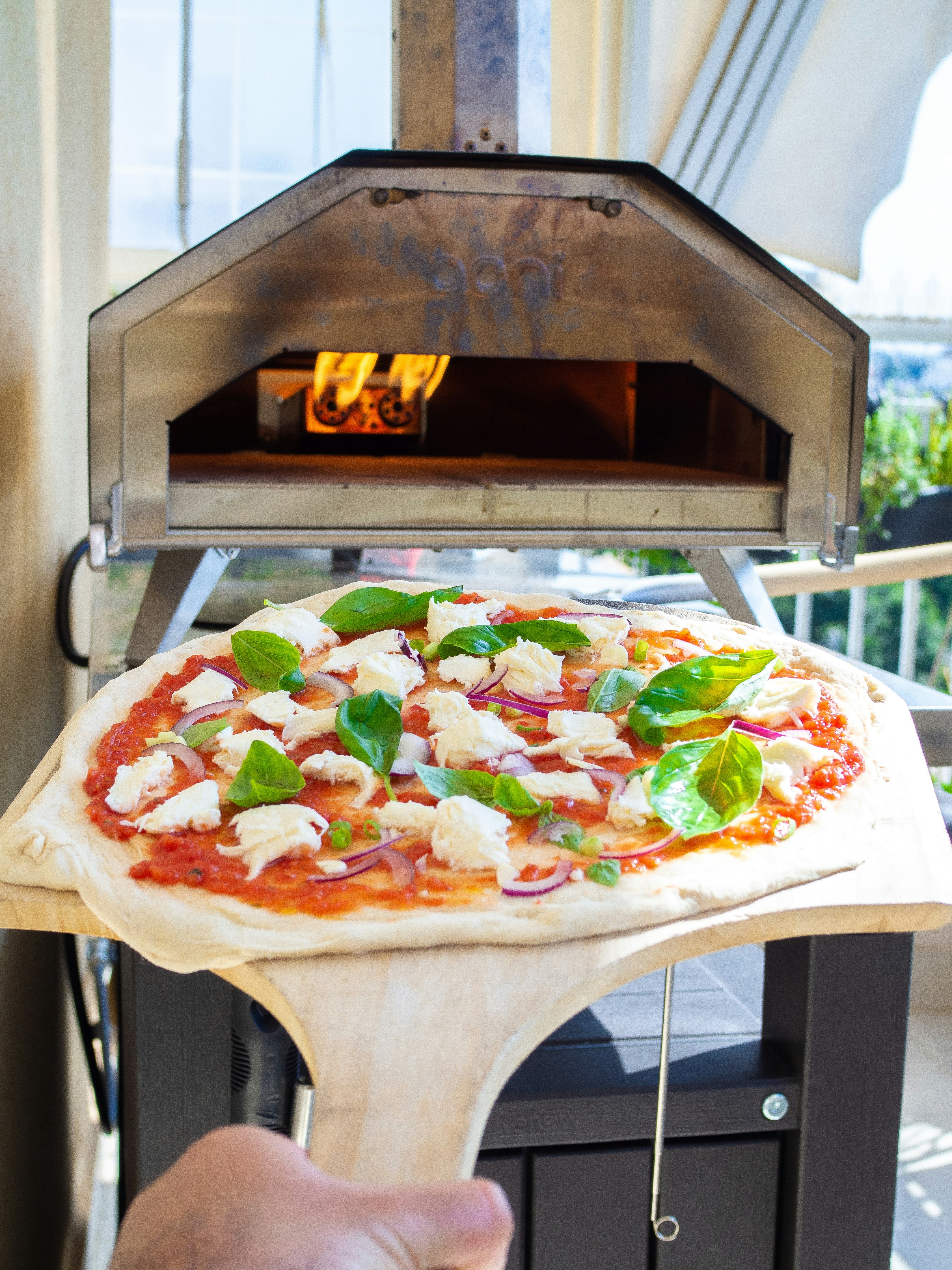 pizza with green and red vegetable on white ceramic plate